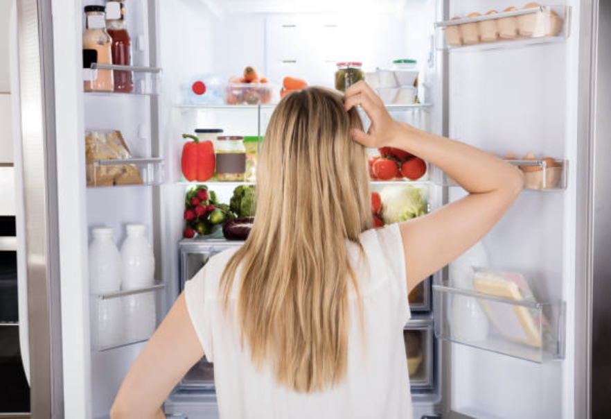 Person looking thoughtfully at food representing reduced food noise on GLP-1 medications